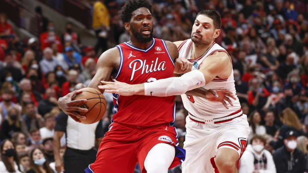 Nov 6, 2021; Chicago, Illinois, USA; Chicago Bulls center Nikola Vucevic (9) fouls Philadelphia 76ers center Joel Embiid (21) during the second half at United Center. Mandatory Credit: Kamil Krzaczynski-USA TODAY Sports
